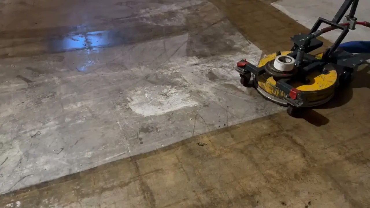 Asbestos adhesive coming off a concrete floor under a 40,000 psi water blasting unit with HEPA vacuum recovery