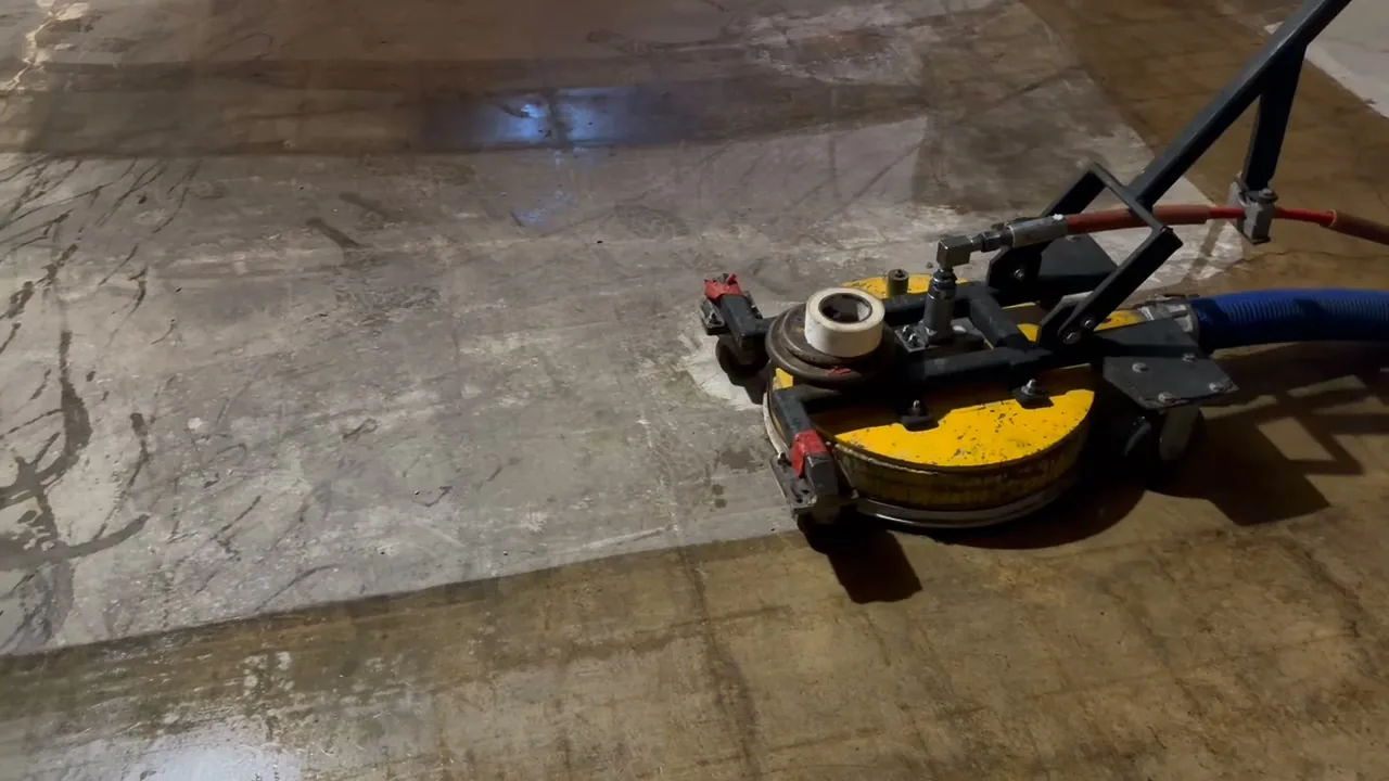 UHP water blasting unit stripping old floor adhesive off a concrete slab after flooring removal