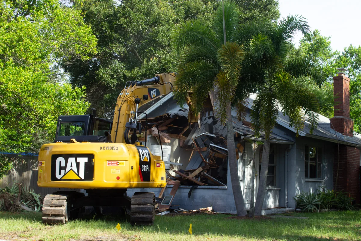 Excavator working through a house demolition